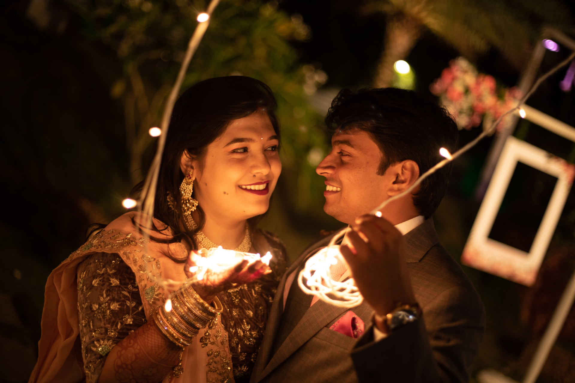 Couple sharing a moment with fairy lights
